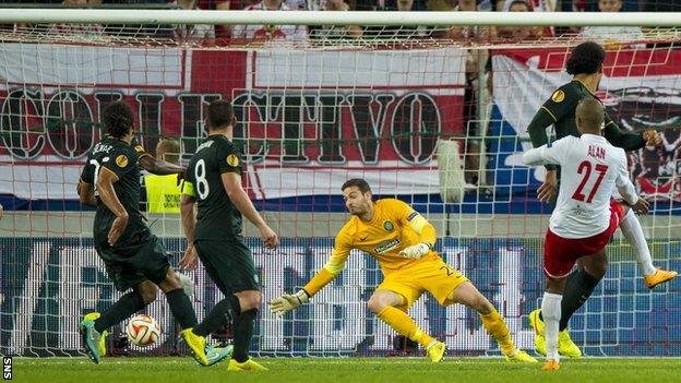 Celtic goalkeeper Craig Gordon makes a save to deny Salzburg's Alan