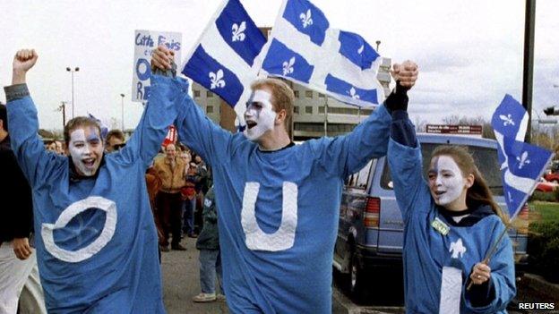 Young "YES" supporters, wearing frocks with the French word "OUI", walk outside a rally in Quebec City, in this 29 October 1995 file picture.