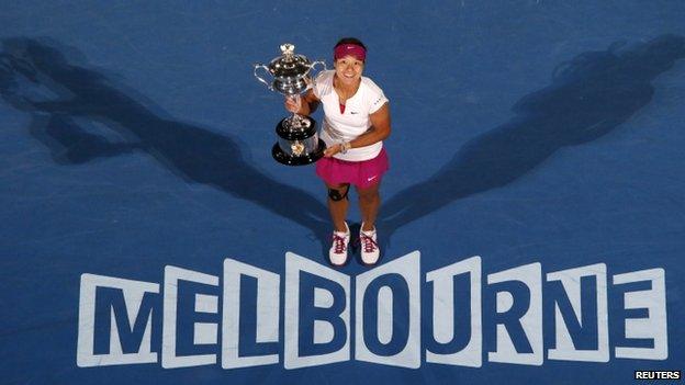 Li Na of China poses with The Daphne Akhurst Memorial Cup after defeating Dominika Cibulkova of Slovakia in their women's singles final match at the Australian Open 2014 tennis tournament in Melbourne in this 25 January 2014 file photo.