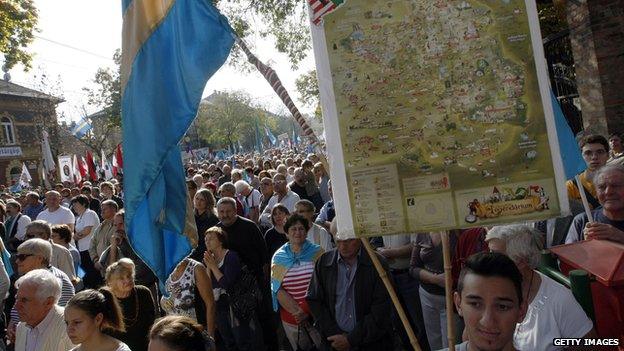 Hungarians hold Hungarian and Transylvanian flags as they take part in a demonstration for the autonomy of Transylvanian territory from Romania in Budapest, Hungary on 27 October 2013.