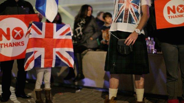 People wait outside the Scottish Parliament in Edinburgh