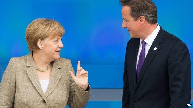 British Prime Minister David Cameron (R) and German Chancellor Angela Merkel meet during the Nato summit in Newport, South Wales, on 4 September 2014.