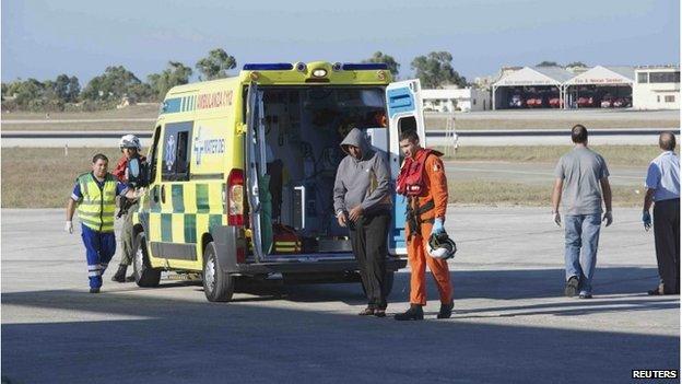 A migrant is brought to Malta by helicopter at the Air Wing base outside Valletta September 14, 2014