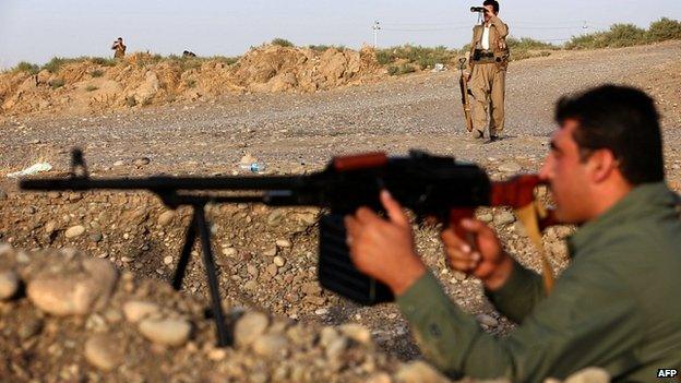 Kurdish peshmerga fighters hold a position on the front line in Gwer district, south of Irbil. 18 Sept 2014