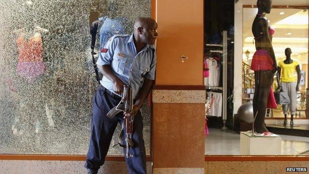 A police officer tries to secure an area inside the Westgate Shopping Centre where gunmen went on a shooting spree in Nairobi, 21 September 2013