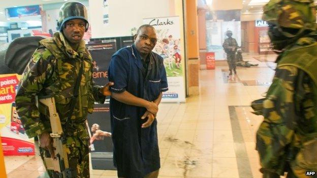 A wounded man is rescued by Kenyan troops at the Westgate mall on 21 September 2013 in Nairobi