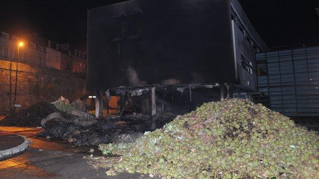 Artichokes and other vegetables dumped outside burnt-out tax office in Morlaix, Brittany (19 September)