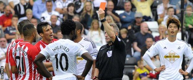 Wilfried Bony is shown the red card