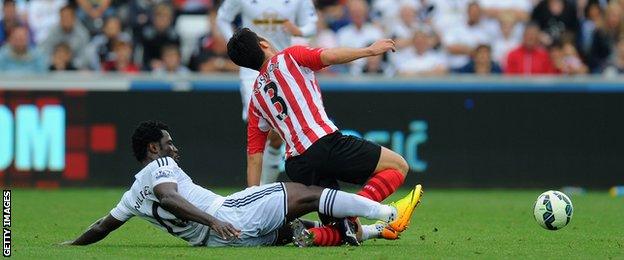 Wilfried Bony slides in on Maya Yoshida