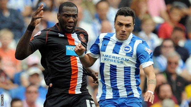 Blackpool's Ishmael Miller (left) and Brighton & Hove Albion's Adrian Colunga battle for the ball