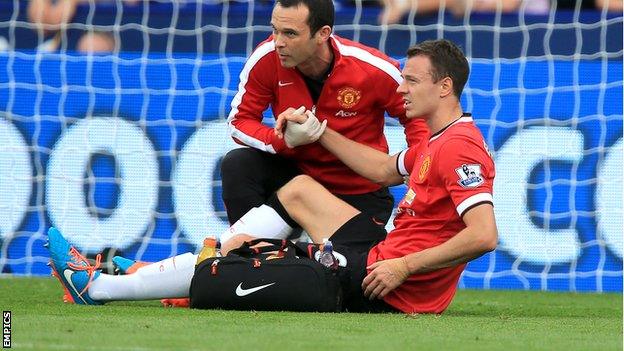 Manchester United defender Jonny Evans receives treatment