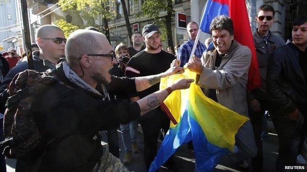 Supporters of pro-Russian separatists in Ukraine tear an Ukrainian flag at their own rally in Moscow - 21 September 2014