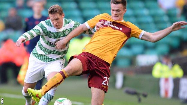 Kris Commons and Fraser Kerr battle for possession during Motherwell's trip to Celtic Park