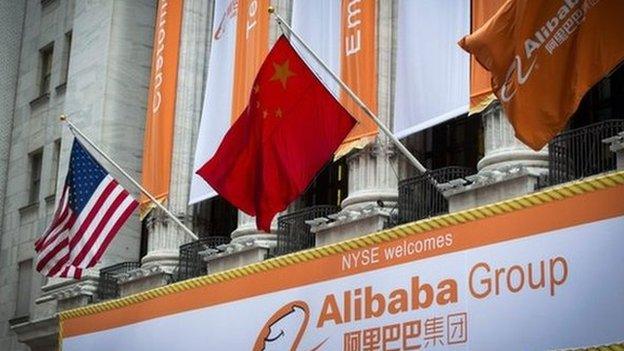 US, Chinese and Alibaba flags outside NYSE