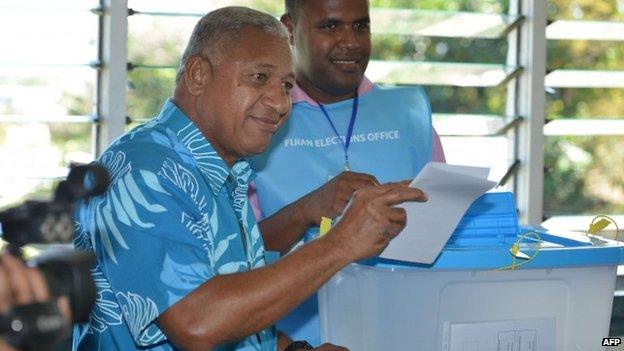 This photo taken on 17 September 2014 shows Fiji's military strongman Voreqe "Frank" Bainimarama (L) casting his election vote at the Vatuwaqa Public School in the capital Suva