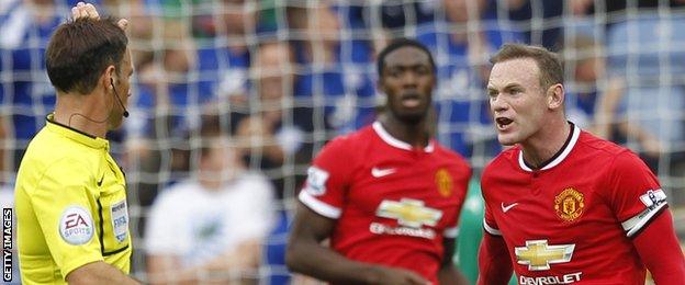 Manchester United striker Wayne Rooney (right) shouts at referee Mark Clattenburg during the 5-3 defeat at Leicester City