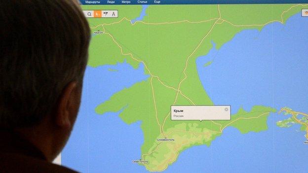 Russian looking at map of Crimea on internet - file pic