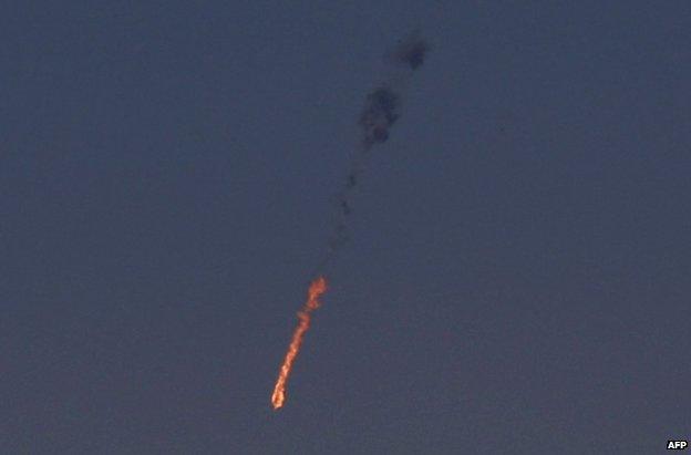 A Syrian plane plummets to the ground in flames over the Golan Heights, 23 September