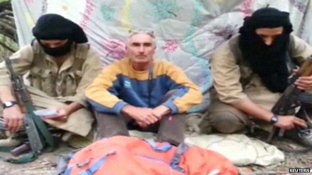 Herve Gourdel (centre) with two men thought to be part of the group holding him