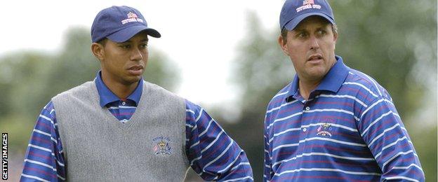 Tiger Woods (left) and Phil Mickelson wait for play during four-ball competition at the 2004 Ryder Cup in Detroit