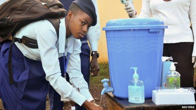 A pupil ashes her hands in Abuja, Nigeria, on 22 September 2014