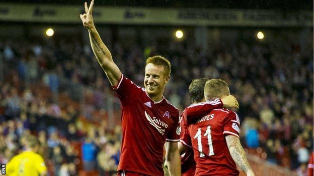 Adam Rooney salutes the Aberdeen support after netting a hat-trick against Livingston.