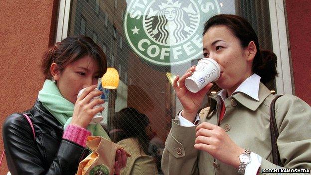 Ladies sipping coffee outside Starbucks Tokyo outlet