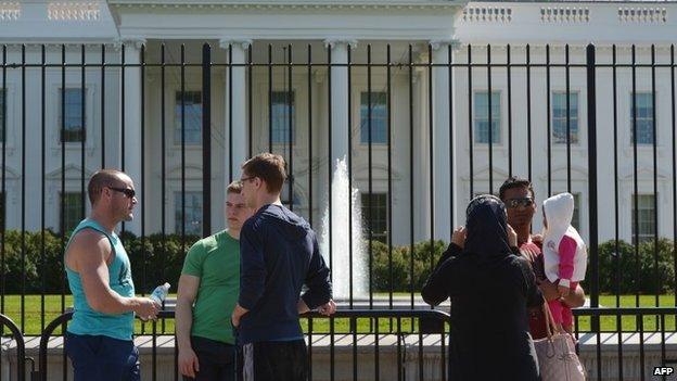 Tourists are seen in front of the White House in Washington, DC 23 September 2014