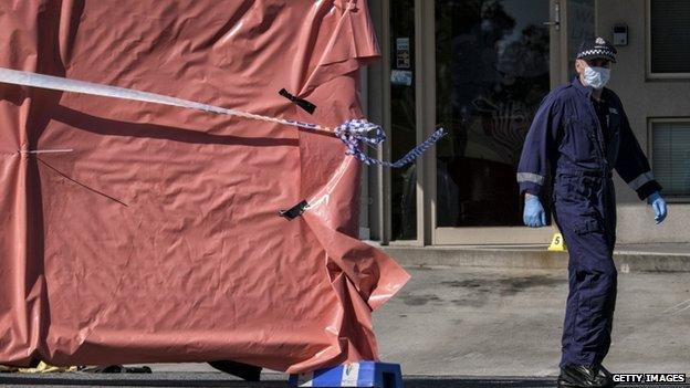 Forensic police are seen at the scene where a man as shot dead after stabbing two counter terrorism officers in the suburb of Endeavour Hills on 24 September 2014 in Melbourne, Australia