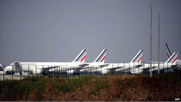 Air France planes are parked on the tarmac of Charles de Gaulle airport