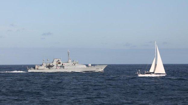 The Irish naval vessel - the LÉ Niamh, sails alongside the detained yacht Makayabella