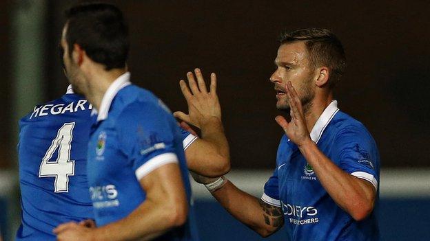 Peter Thompson is congratulated by Chris Hegarty after putting Linfield ahead at Windsor Park