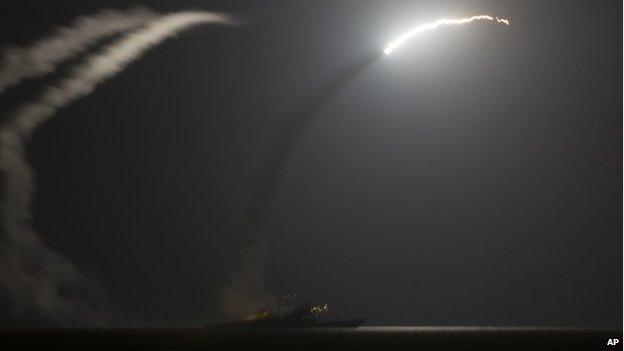 Guided-missile cruiser USS Philippine Sea (CG 58) launches a Tomahawk cruise missile as seen from the aircraft carrier USS George HW Bush 23 September 2014