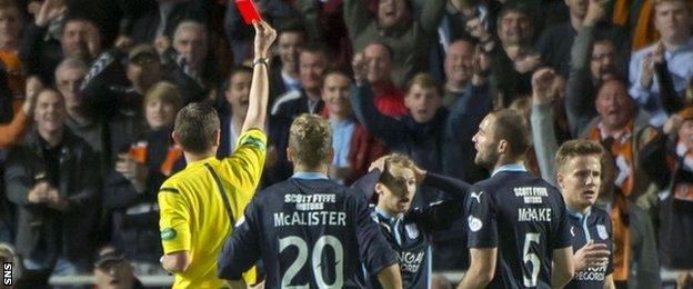 Dundee's Martin Boyle is sent off after fouling Dundee United's Stuart Armstrong