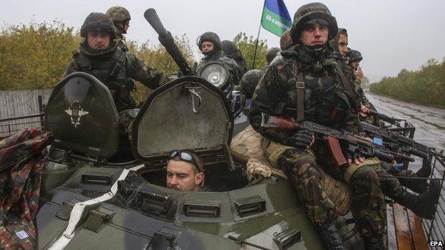 Ukrainian servicemen drive on a military vehicle on a road near the eastern city of Artyomovsk, Donetsk area, Ukraine, 24 September 2014