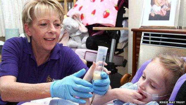 Jessie May nurse treating a young patient