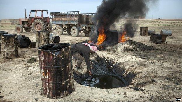 A man works at a makeshift, or teapot, oil refinery in Syria's Raqqa province (15 April 2013)