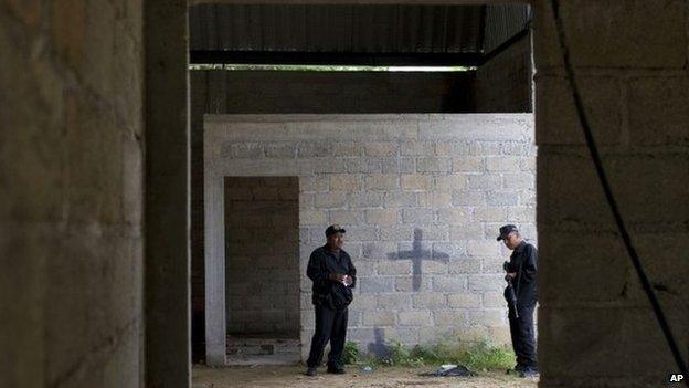 Mexican state police on 3 July 2014 inside a warehouse where a shootout between Mexican soldiers and alleged criminals on the outskirts of the village of San Pedro Limon, in Mexico state, Mexico