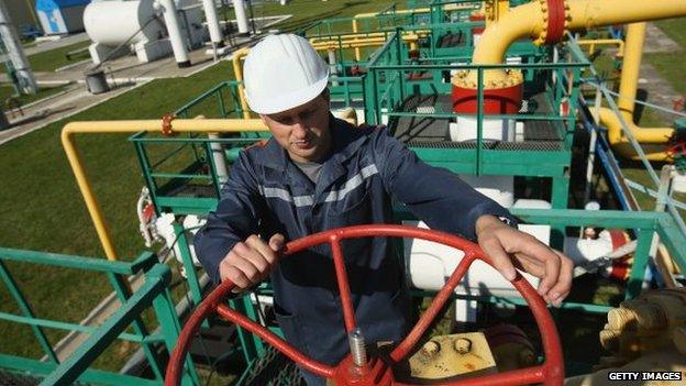 Darshava gas facility in Ukraine, man with manual wheel operating valve