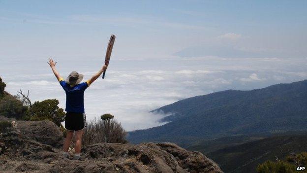 England women national cricket team vice-captain Heather Knight raises her arms on the second day of a trek up to Kilimanjaro, Tanzania - 21 September 2014