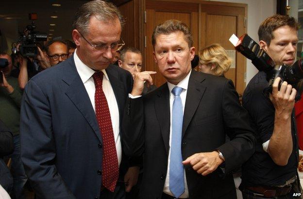 Gazprom CEO Alexei Miller (C) and Russian Energy Minister Alexander Novak (L) leave the talks in Berlin, 26 September