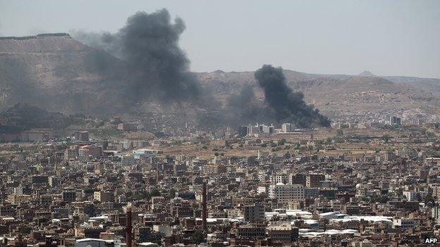 Smoke rises from the main gate of the army's fist armoured division