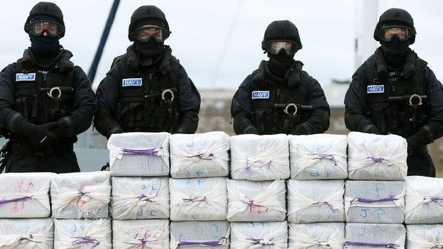 Members of the Irish navy stand guard over more than a tonne of cocaine seized from a yacht off the coast of County Cork on Tuesday