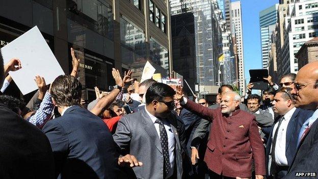 Narendra Modi (right) walks the streets of Manhattan