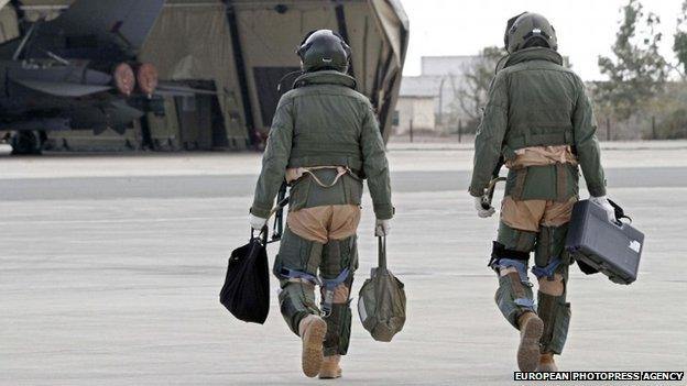 Crew of a British tornado fighter jet walk on the apron of an airstrip at RAF Akrotiri in Cyprus