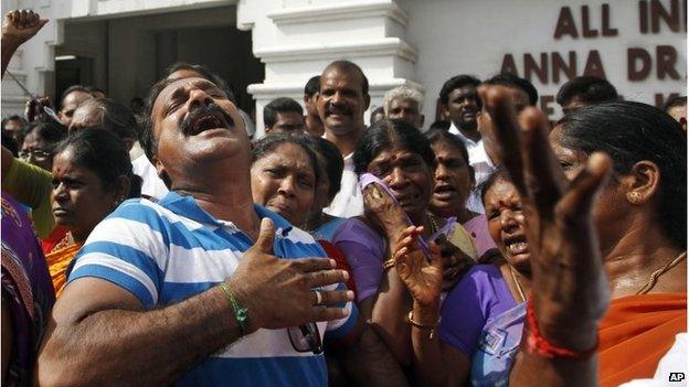 AIADMK party workers cry after a verdict was handed down to Jayaram Jayalalitha.