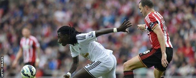 Swansea striker Bafetimbi Gomis gets away from Sunderland defender John O'Shea