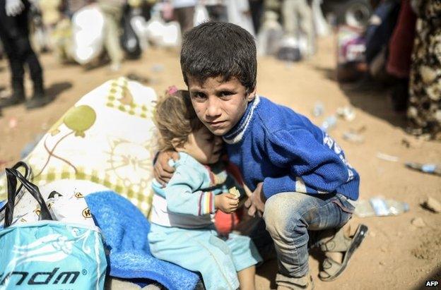 Syrian Kurdish refugees on the Turkish side of the border at Suruc, 27 September