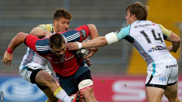 Ospreys try-scorer Jeff Hassler and team-mate Rhys Webb attempt to halt Munster's CJ Stander