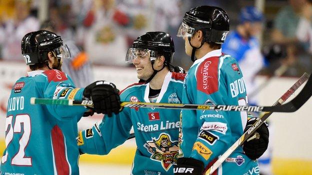 Mark Garside celebrates his Daryl Lloyd and Cody Brookwell after scoring Belfast's clinching fourth goal against Coventry